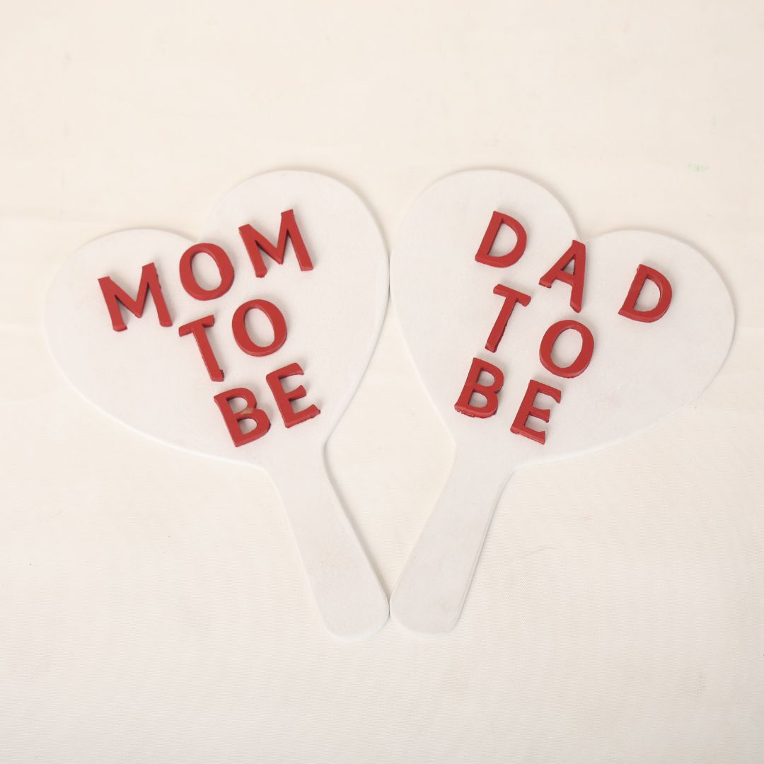 Mom-to-Be and Dad-to-Be Sign Board Set: A matching set of Mom-to-Be and Dad-to-Be sign boards, styled for maternity photoshoots, featuring elegant lettering and a soft, neutral design ideal for any setup.