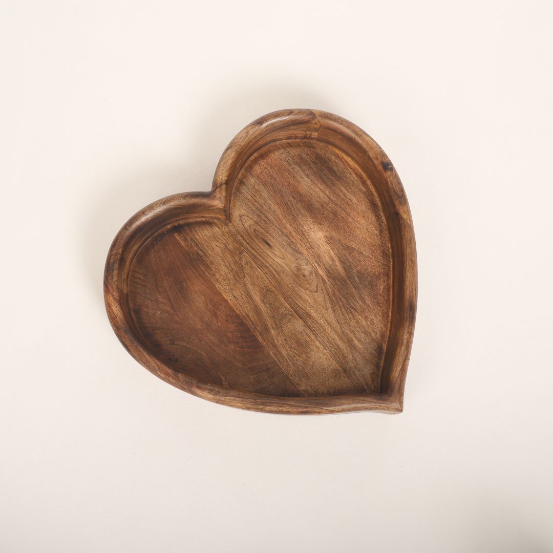 A wooden heart-shaped bowl designed as a prop for newborn baby photoshoots. The bowl has smooth edges and a natural wood finish, providing a cozy and charming setting to cradle a baby. Ideal for capturing heartfelt and memorable moments.