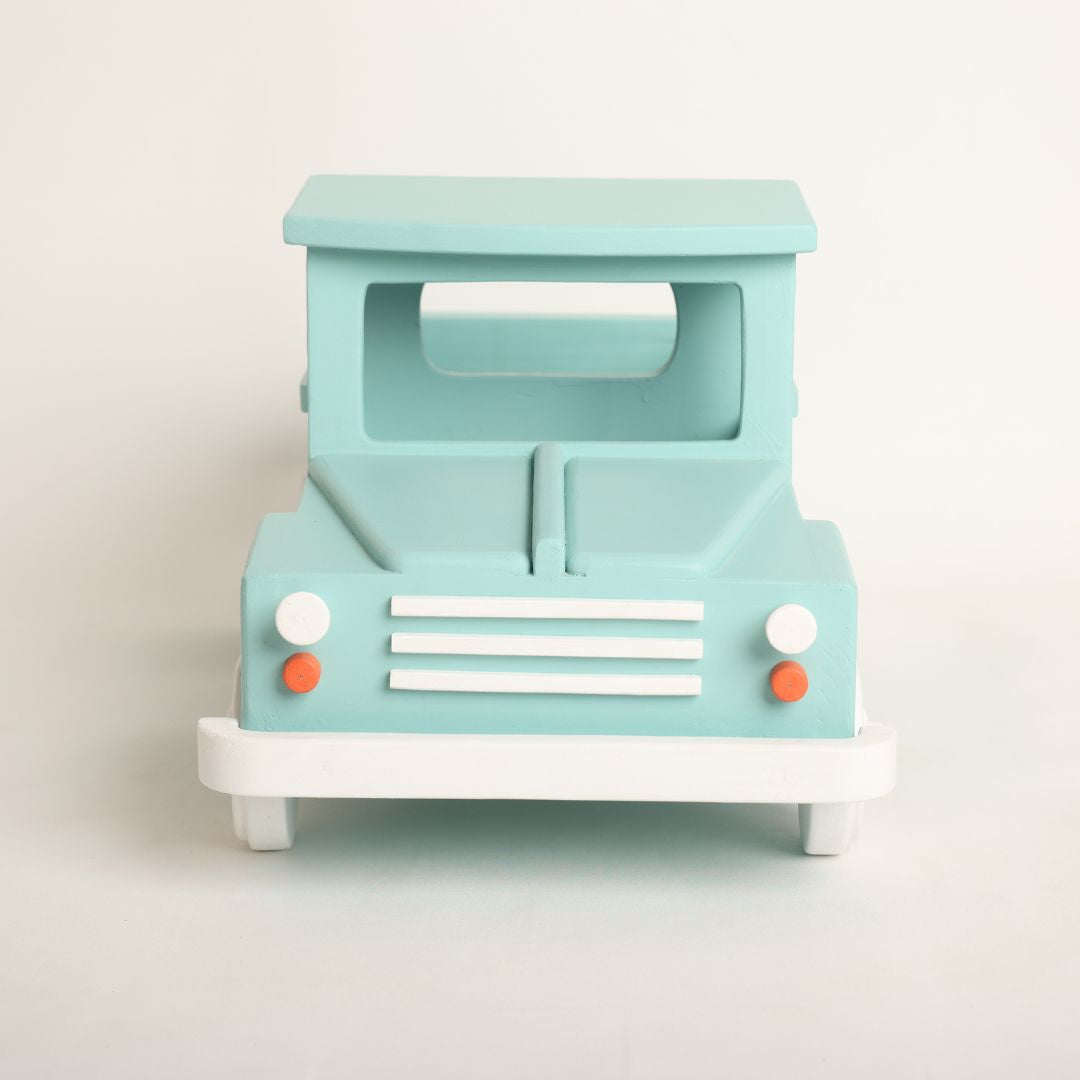 wooden truck baby prop designed for baby photoshoots. The truck features a vintage-inspired design with detailed wheels, a spacious cargo area, and a distressed finish. Perfect for creating adorable and unique photography setups for newborns and toddlers.