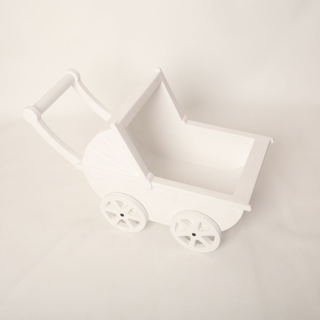 A vintage-style pram baby prop with soft pastel accents, designed for newborn photoshoots.