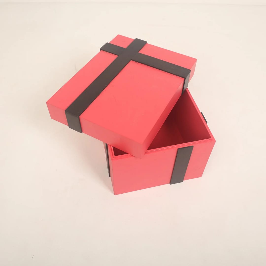 A beautifully crafted gift box baby prop, styled with ribbons and soft padding, ideal for newborn and sitter photoshoots, available at a baby prop store.