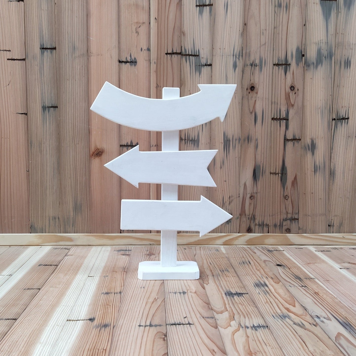 A cute and colorful Direction Sign Board baby photoshoot prop featuring multiple arrows and customizable directions, set in a playful and creative photoshoot