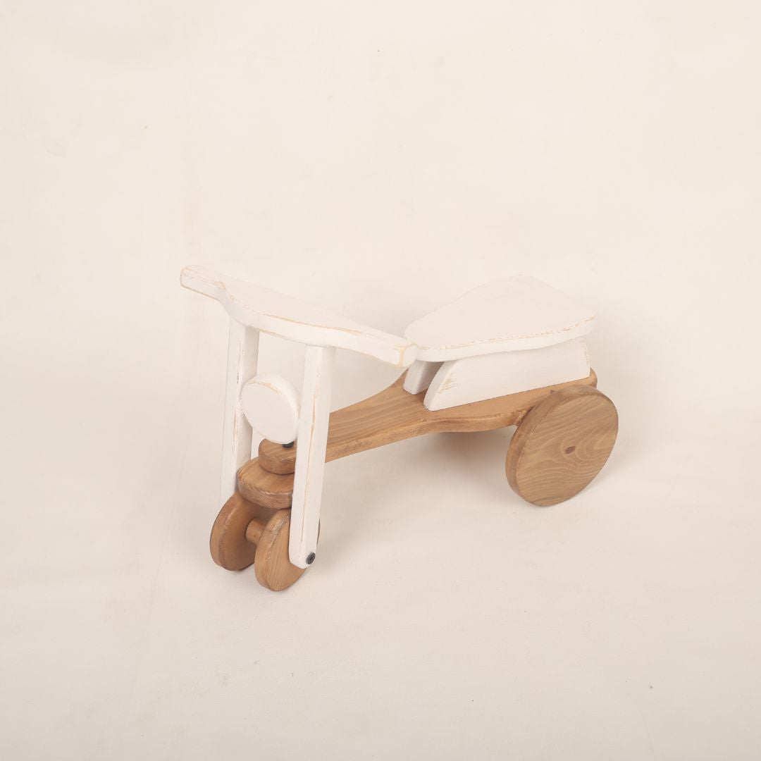 A colorful scooter baby prop used for adorable baby photoshoots, showcasing vibrant colors and a playful design. Perfect for capturing precious moments.