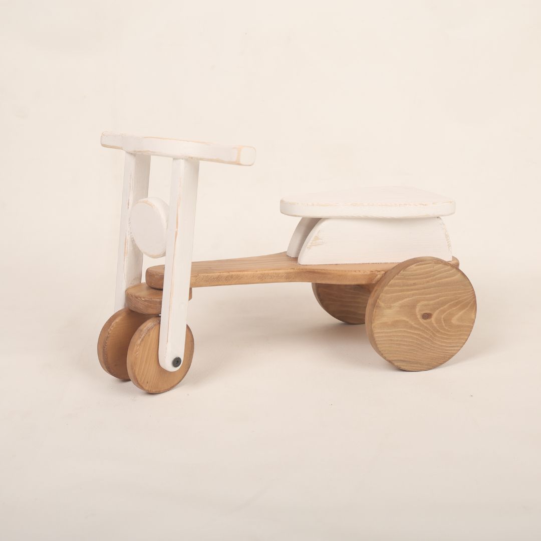 A colorful scooter baby prop used for adorable baby photoshoots, showcasing vibrant colors and a playful design. Perfect for capturing precious moments.
