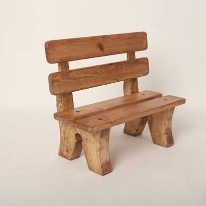 Adorable wooden garden bench baby prop, designed for newborn and toddler photoshoots. Features a rustic charm with a natural wood finish, perfect for outdoor or garden-themed photography sessions.