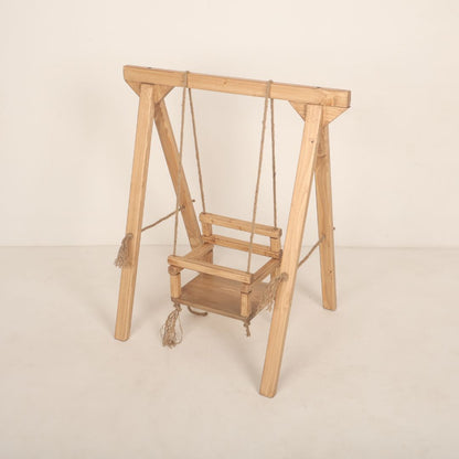 Wooden swing baby prop with soft cushions and decorative ropes, designed for newborn and toddler photoshoots, adding a playful and whimsical charm to any setup.