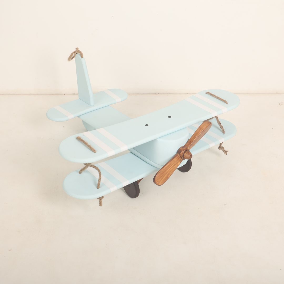 A vintage-style biplane baby prop crafted for baby photoshoots. The wooden biplane features detailed wings, a miniature propeller, and a distressed finish for a classic look. Its cozy seating area is perfect for posing babies, adding a touch of adventure and nostalgia to the photoshoot.