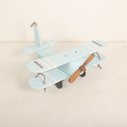 A vintage-style biplane baby prop crafted for baby photoshoots. The wooden biplane features detailed wings, a miniature propeller, and a distressed finish for a classic look. Its cozy seating area is perfect for posing babies, adding a touch of adventure and nostalgia to the photoshoot.
