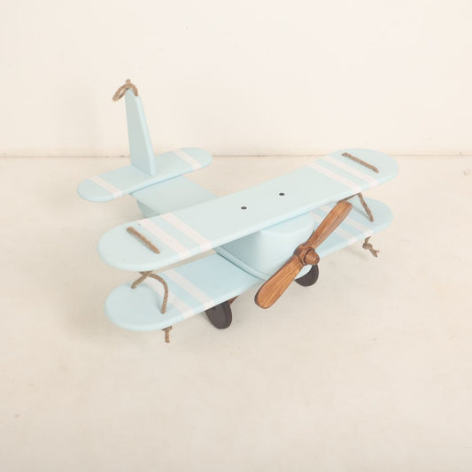 A vintage-style biplane baby prop crafted for baby photoshoots. The wooden biplane features detailed wings, a miniature propeller, and a distressed finish for a classic look. Its cozy seating area is perfect for posing babies, adding a touch of adventure and nostalgia to the photoshoot.