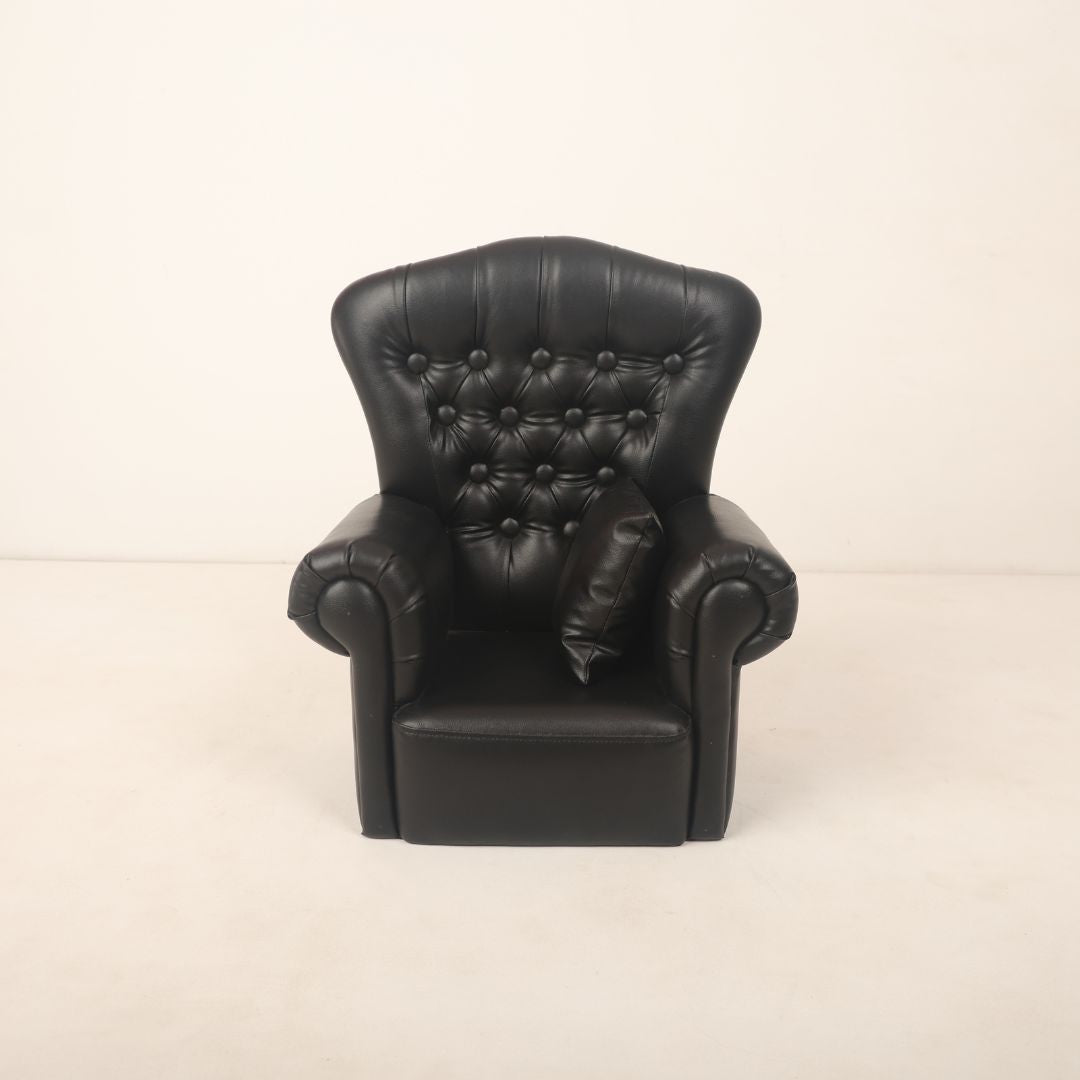 A stylish boss baby sofa prop, designed for baby photoshoots, featuring a sleek, modern design with cushioned seating and armrests. Its bold structure gives off an executive vibe, ideal for creating a "Boss Baby" theme. The sofa is perfectly sized for little ones, providing comfort while adding a touch of sophistication to the photoshoot setup.