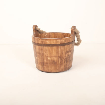 A cozy, vintage-style bucket prop designed for newborn photoshoots, providing a cute and comfortable setting for little ones.