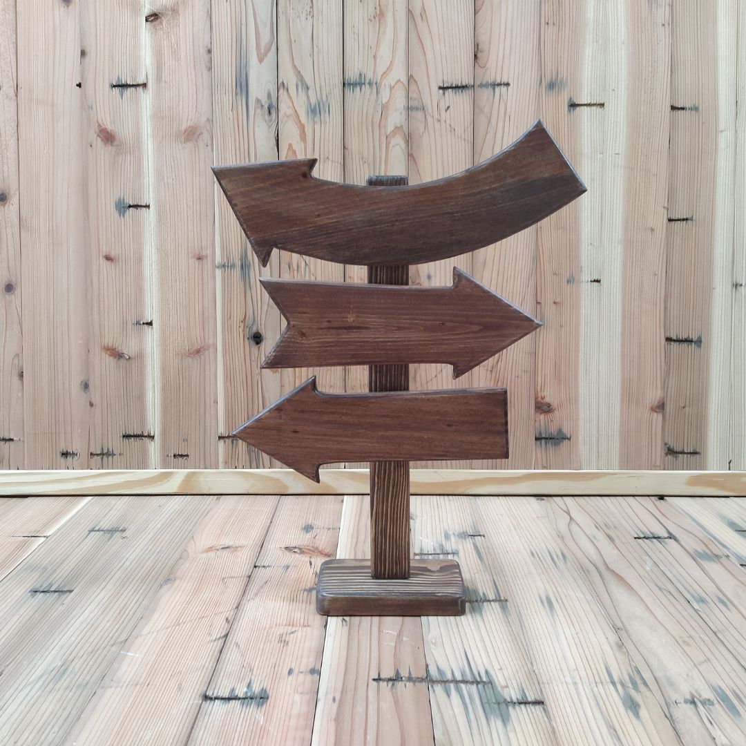 A cute and colorful Direction Sign Board baby photoshoot prop featuring multiple arrows and customizable directions, set in a playful and creative photoshoot