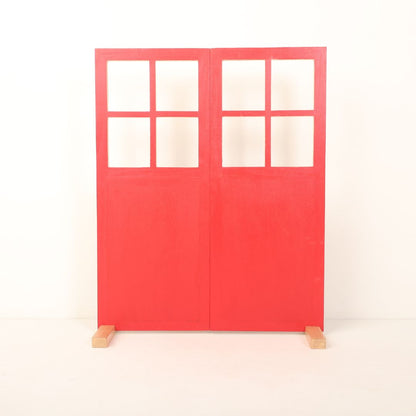 A dual-shade double leaf door prop with one side in wooden brown and the other in either red or white, designed for newborn, maternity, and event photography.