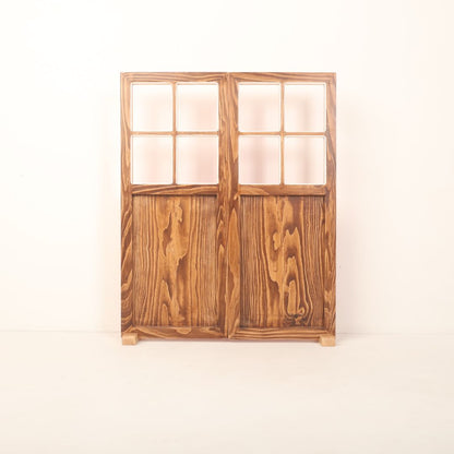 A dual-shade double leaf door prop with one side in wooden brown and the other in either red or white, designed for newborn, maternity, and event photography.
