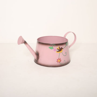 A garden sprinkler baby photoshoot prop, styled outdoors with floral decor, creating a whimsical theme for baby photography sessions.