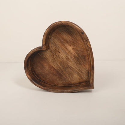 A wooden heart-shaped bowl designed as a prop for newborn baby photoshoots. The bowl has smooth edges and a natural wood finish, providing a cozy and charming setting to cradle a baby. Ideal for capturing heartfelt and memorable moments.