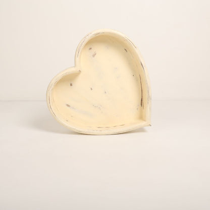 A wooden heart-shaped bowl designed as a prop for newborn baby photoshoots. The bowl has smooth edges and a natural wood finish, providing a cozy and charming setting to cradle a baby. Ideal for capturing heartfelt and memorable moments.