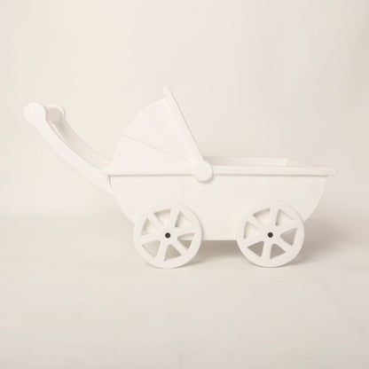 A vintage-style pram baby prop with soft pastel accents, designed for newborn photoshoots.