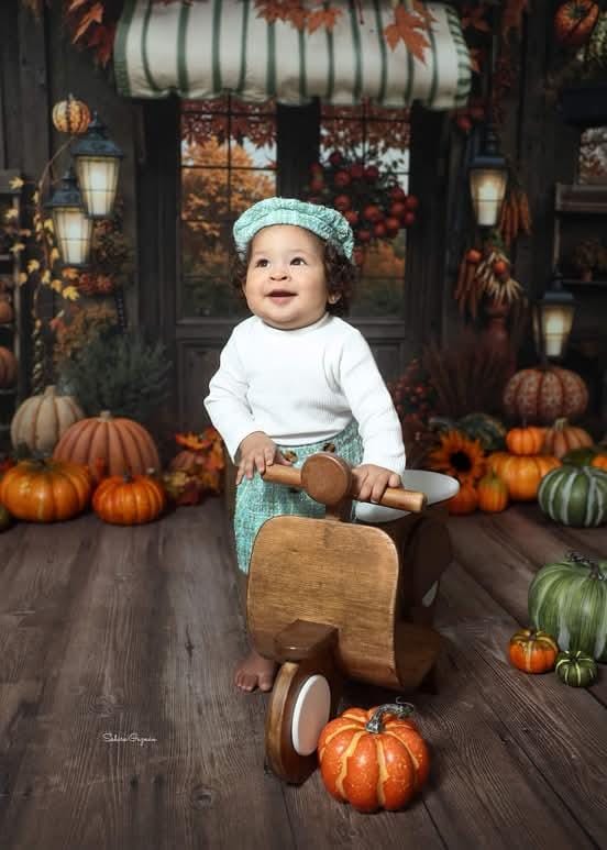 Baby sitting on a scooter baby prop for newborn and sitter photoshoot, ideal for studio photographers.