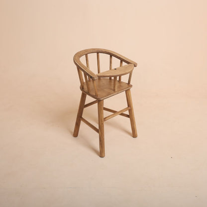 Brown wooden high chair baby photoshoot prop with baby sitting