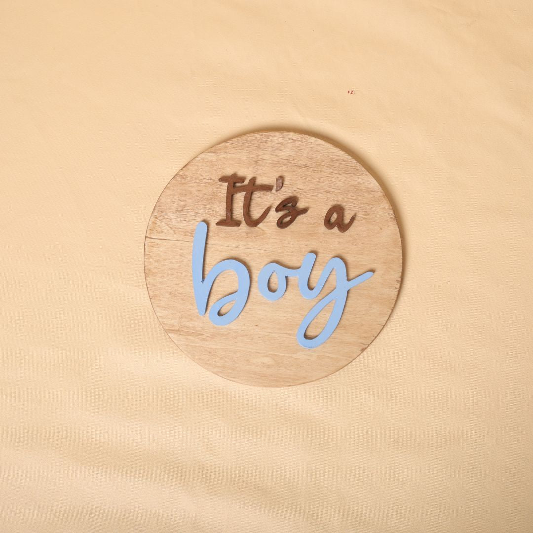 Gender reveal prop for maternity photoshoot featuring 'It's a Boy' and 'It's a Girl' signs, perfect for expecting mothers