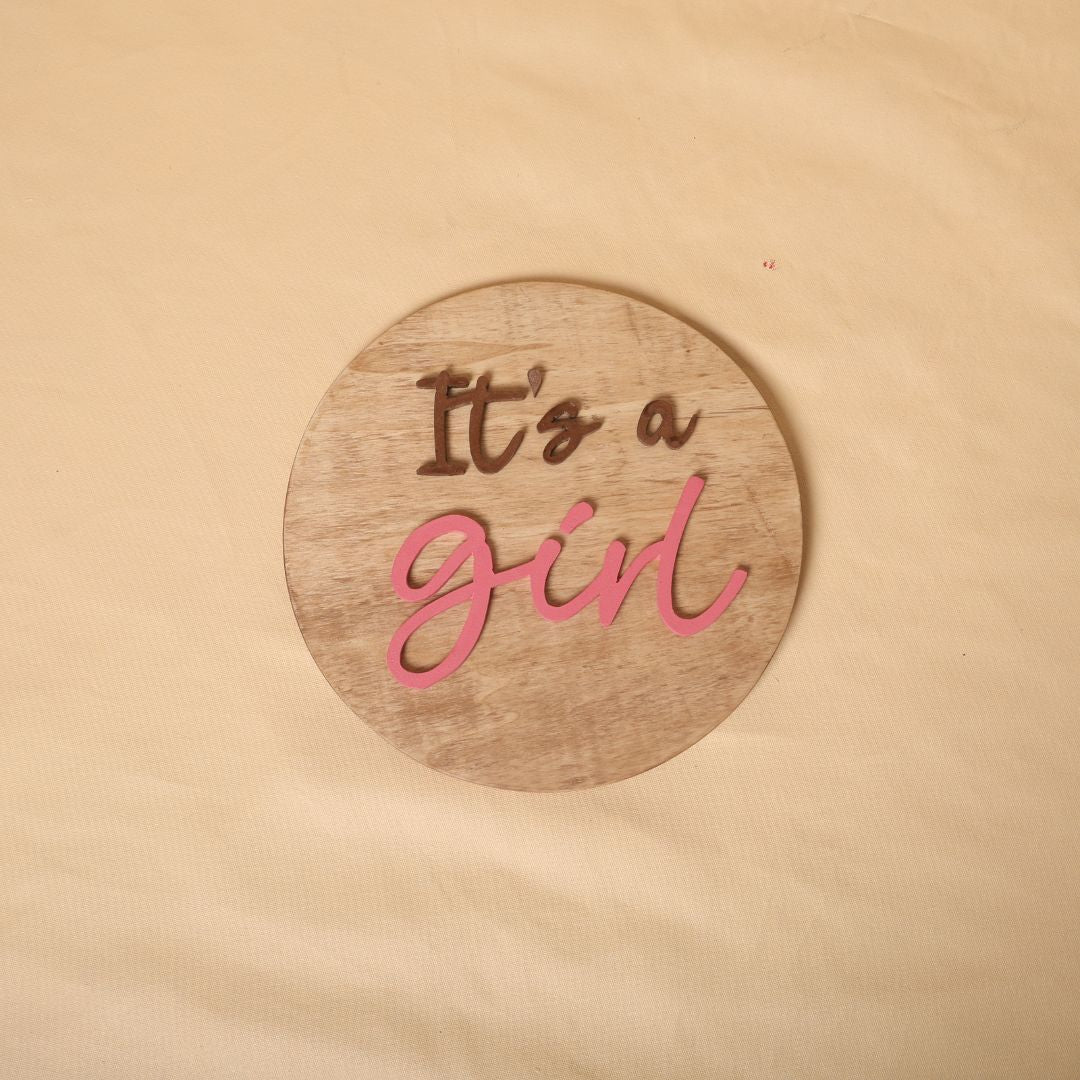 Gender reveal prop for maternity photoshoot featuring 'It's a Boy' and 'It's a Girl' signs, perfect for expecting mothers