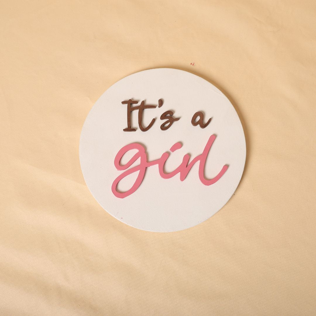 Gender reveal prop for maternity photoshoot featuring 'It's a Boy' and 'It's a Girl' signs, perfect for expecting mothers