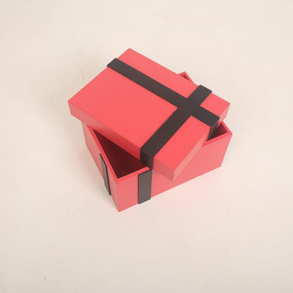 A beautifully crafted gift box baby prop, styled with ribbons and soft padding, ideal for newborn and sitter photoshoots, available at a baby prop store.