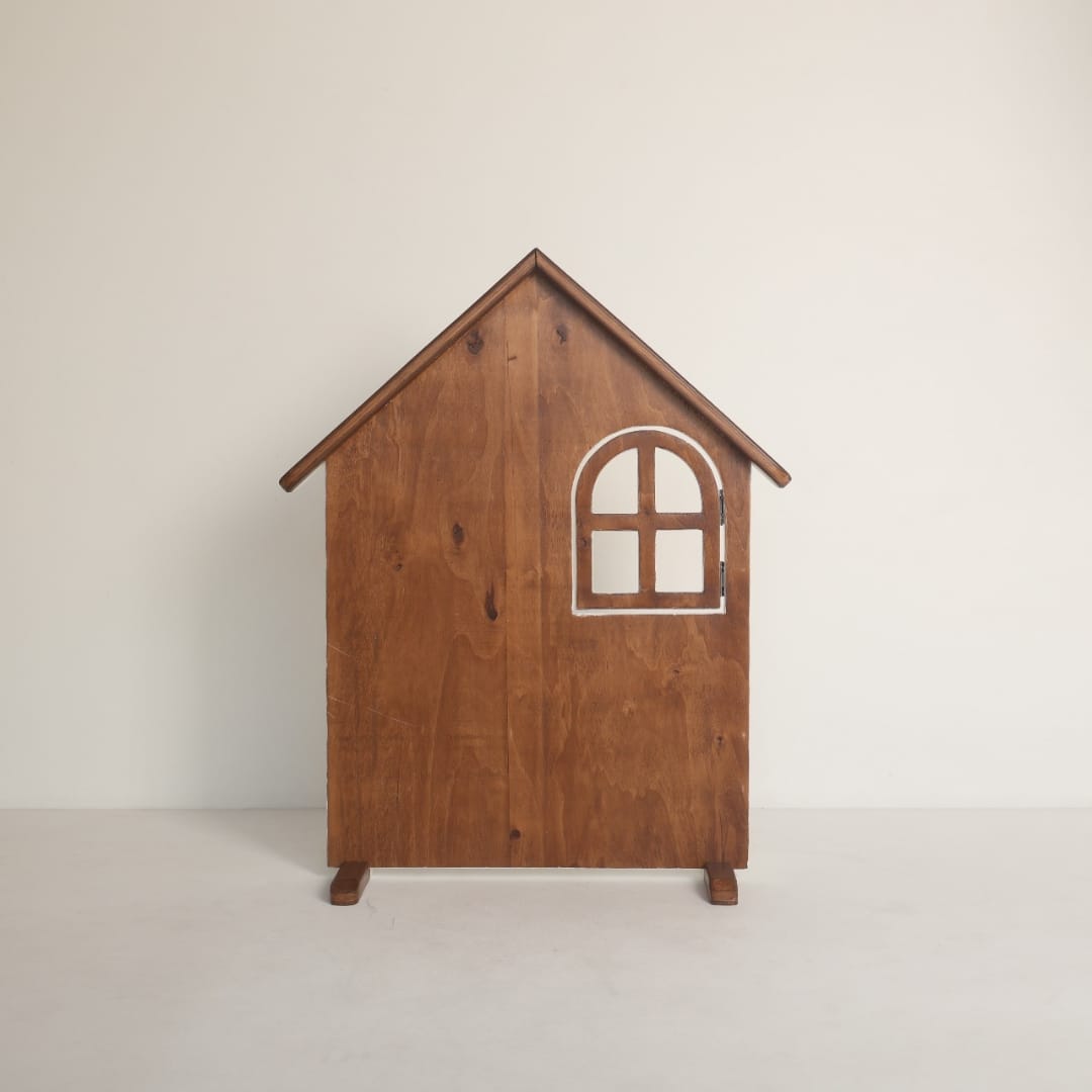 A wooden house-shaped baby prop styled for newborn photography, featuring rustic details perfect for a cottage-themed photoshoot.