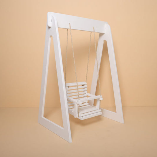Krishna Janmashtami themed wooden swing baby photoshoot prop in festive setup