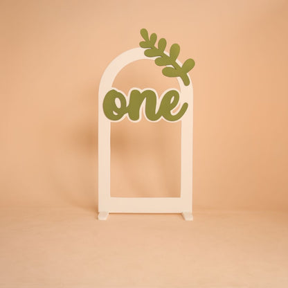 Leaf themed arch baby photoshoot prop with one milestone, nature inspired setup for first birthday shoot