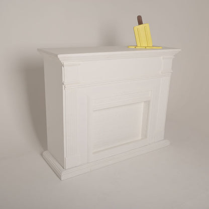 Elegant white fireplace prop styled for a cozy maternity photoshoot setup