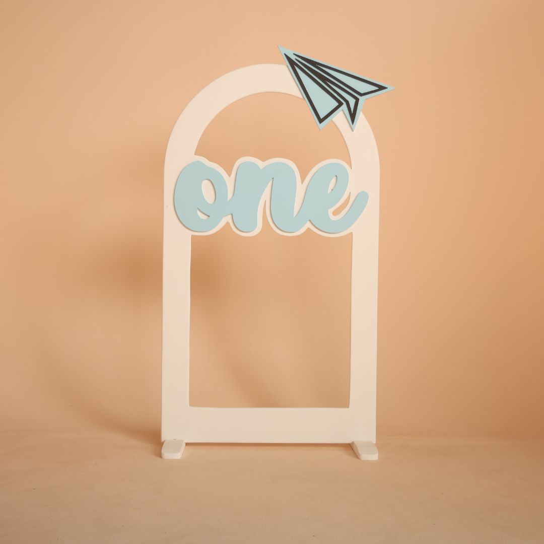 Paper plane themed arch baby photoshoot prop with one milestone, travel inspired first birthday setup