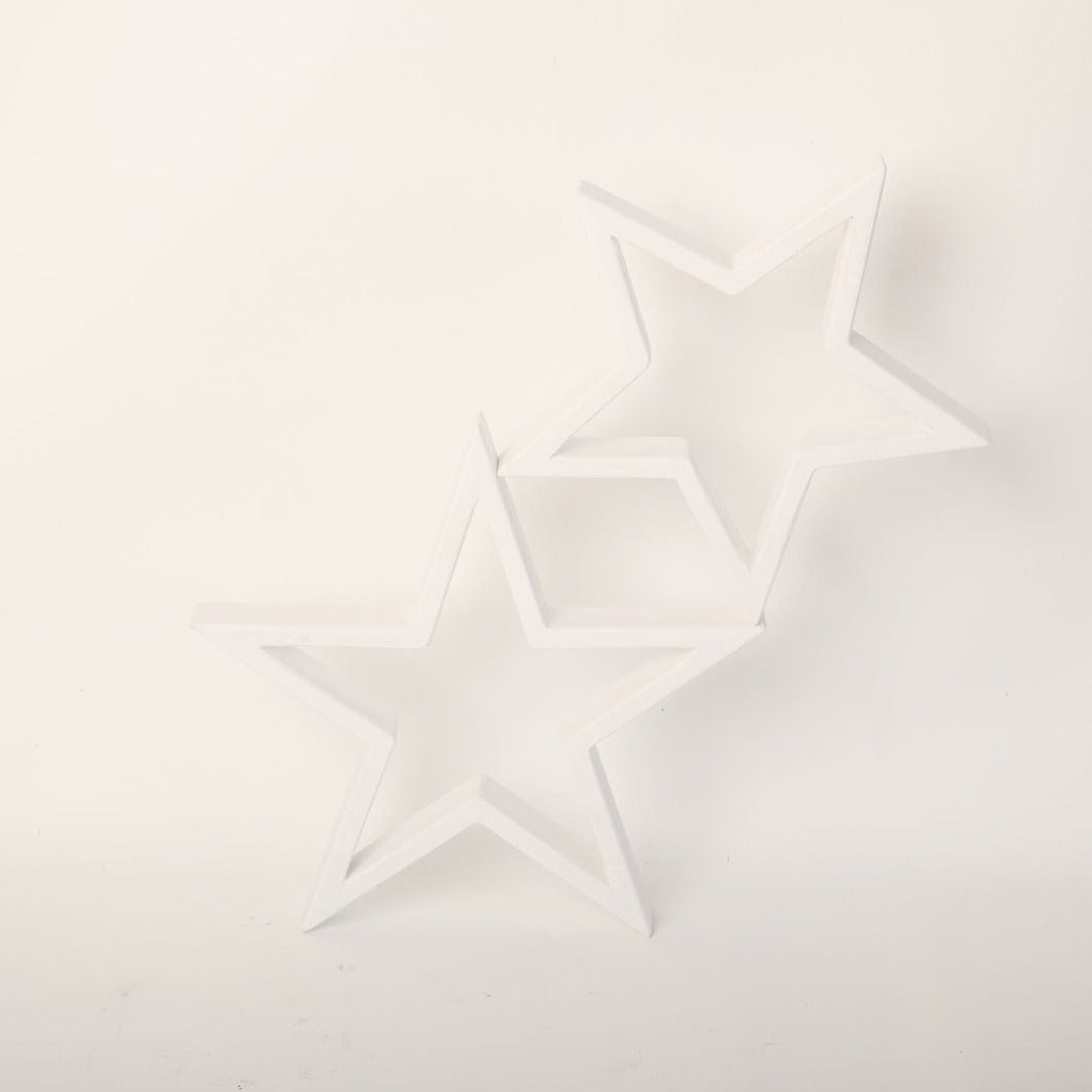 An arrangement of wooden stars, painted in soft pastel colors, hangs delicately above a baby's crib. Each star is intricately crafted, with visible wood grain adding texture to the surface. The stars are suspended by thin, transparent strings, creating a whimsical and enchanting display. Soft light casts gentle shadows on the wall behind, creating a serene and cozy atmosphere. This charming baby prop adds a touch of rustic elegance to any nursery, inviting dreams and imagination to flourish.