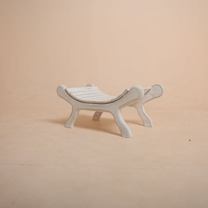 White wooden bench baby photoshoot prop with baby sitting comfortably