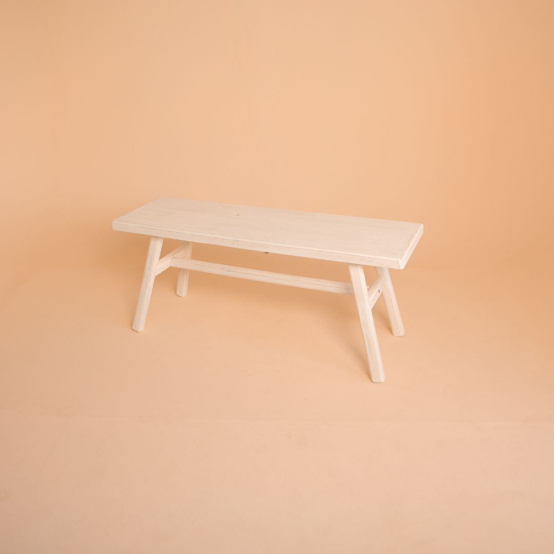 Vintage rustic white bench prop ideal for maternity, sitter, newborn, and fashion portrait sessions in a studio setup.