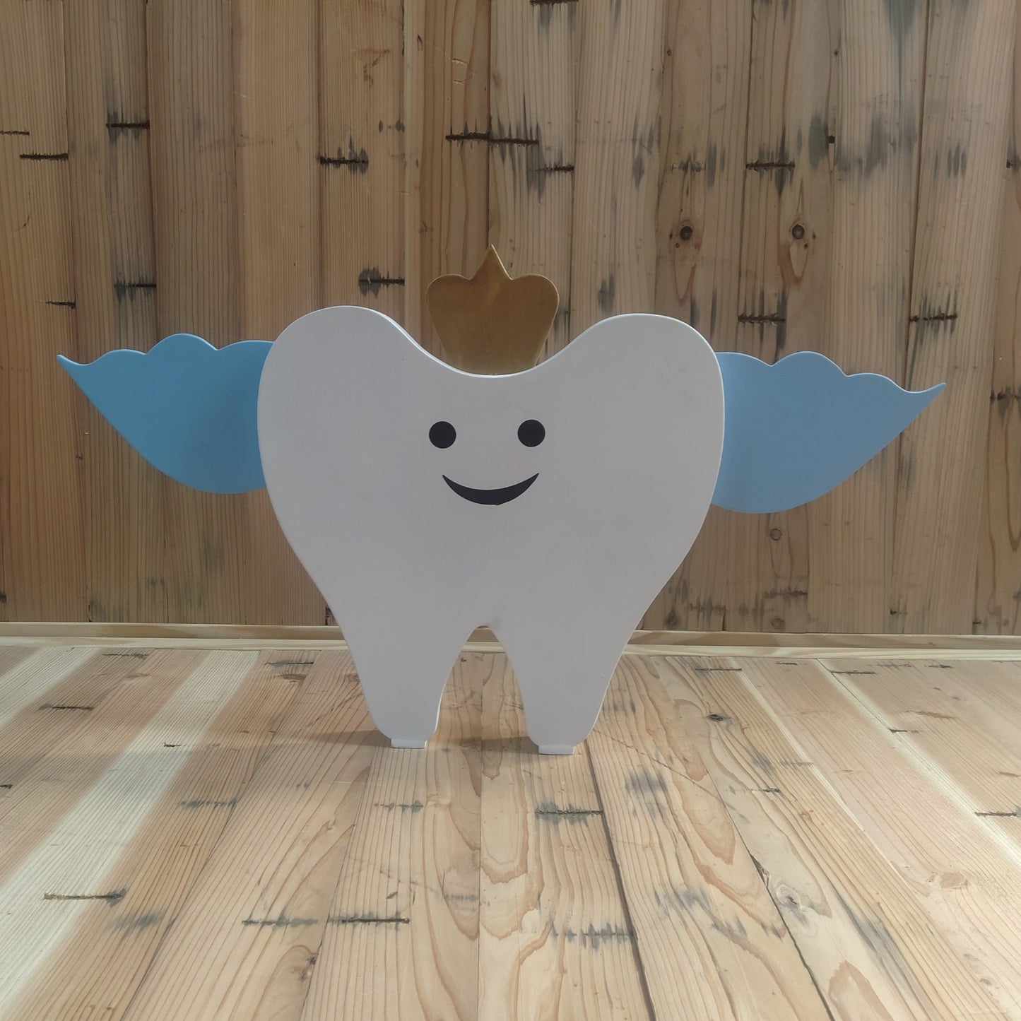 A charming tooth-shaped baby photoshoot prop made of smooth, durable material, styled with a soft pastel background, perfect for milestone and dentist-themed baby photography sessions.